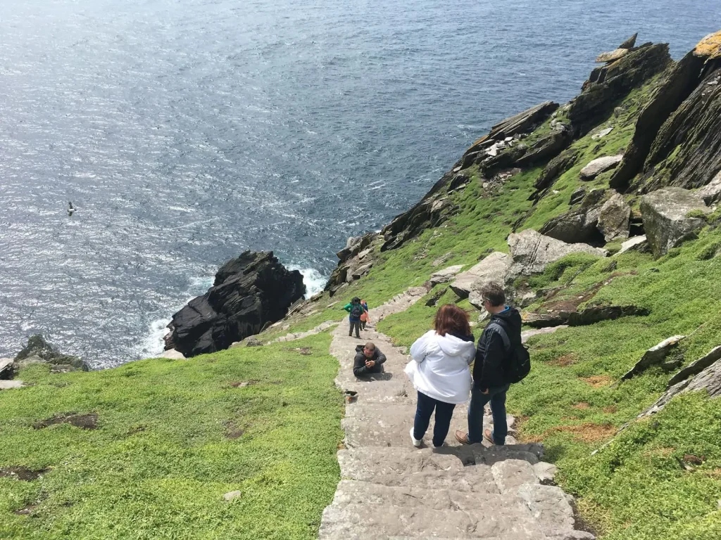 Safety at Skellig Michael Visitors walking down the stone steps on Skellig Michael