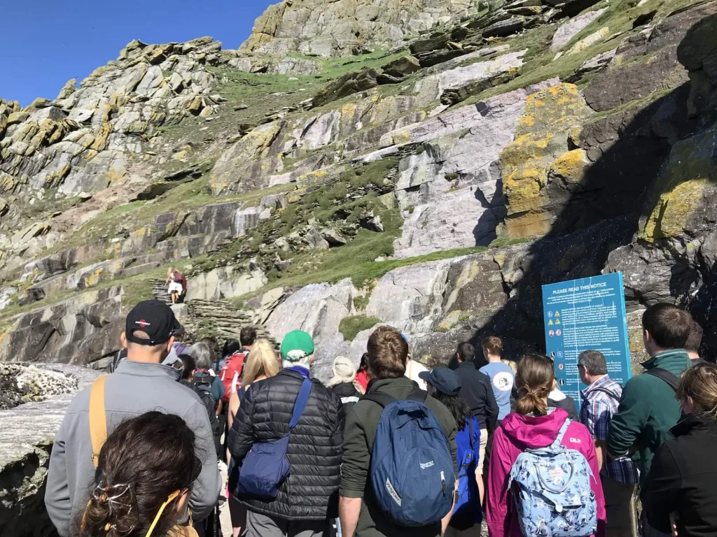 Landing Tour visitors ascending stone steps on Skellig Michael